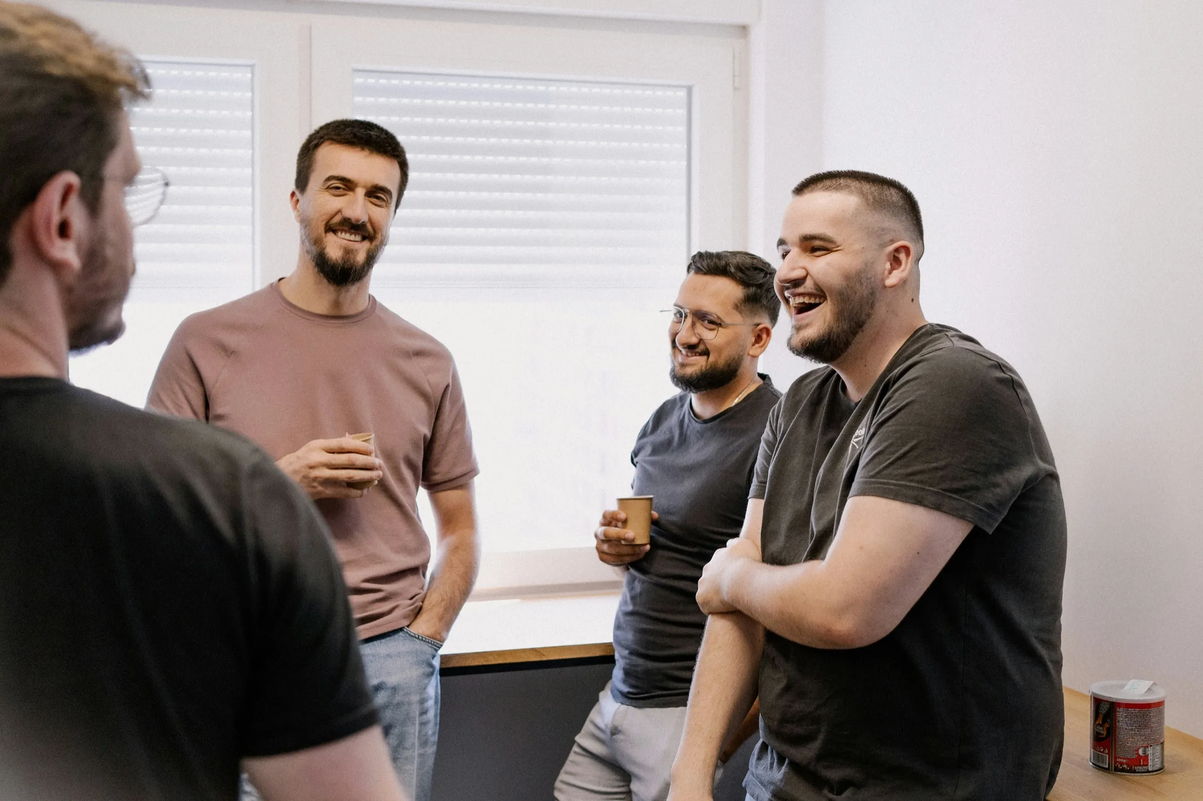 Developers laughing together over coffee